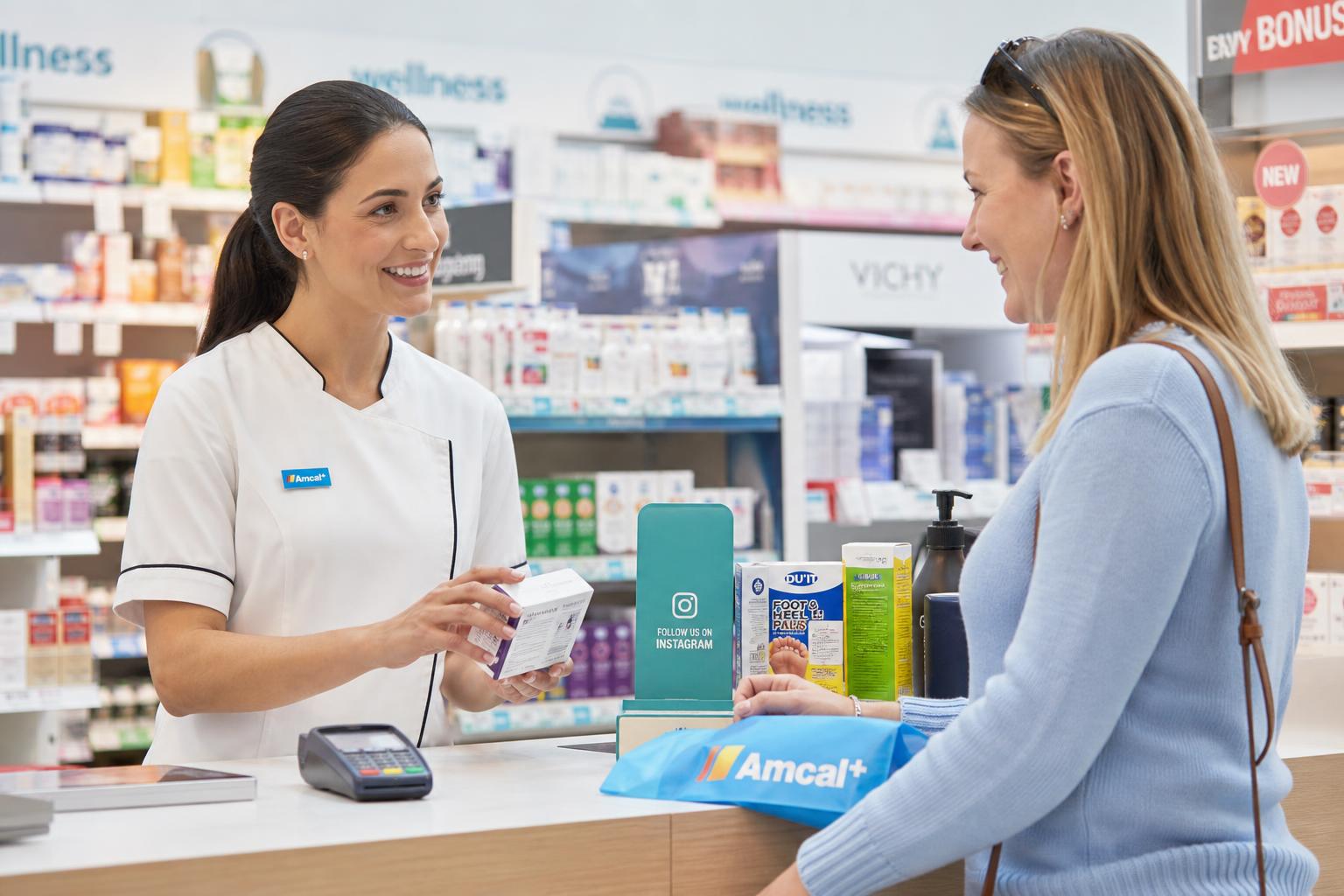 Customer completing a retail purchase at a modern pharmacy counter